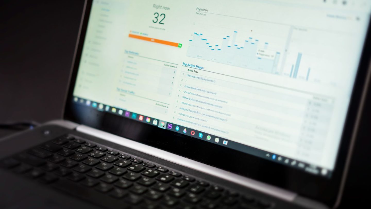 Laptop screen showing a website analytics overview with active users and top active pages