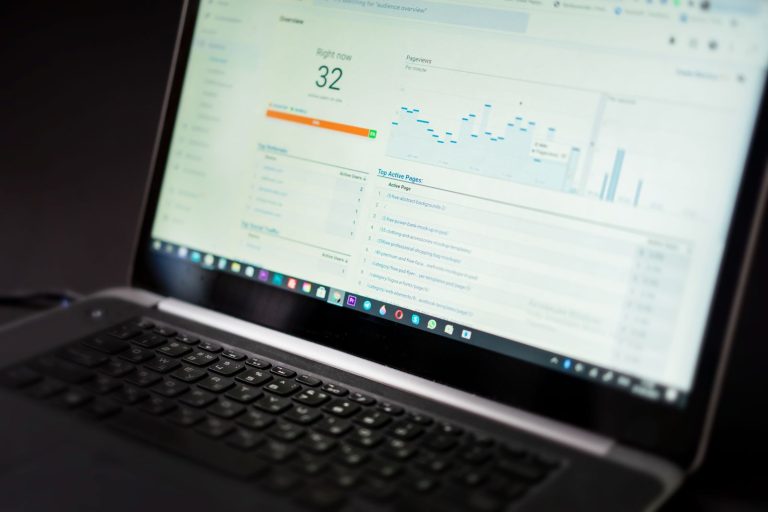 Laptop screen showing a website analytics overview with active users and top active pages